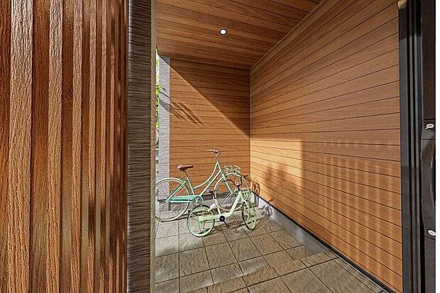 【玄関横の屋内サイクルスぺース】小さな子どもを乗せる自転車も、雨の日でも濡れることなく安心して乗り降りできます。自転車を屋根の下で保管できるため、雨による劣化を防ぎ、防犯性も高まります。
