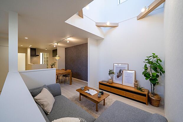 【【4号地・LDK】】吹き抜け部分に施した梁とライトが温もりを添える、心地よいリビング・ダイニング。約20.5帖の広々とした住空間で、家族時間をゆったりと楽しむことができます。