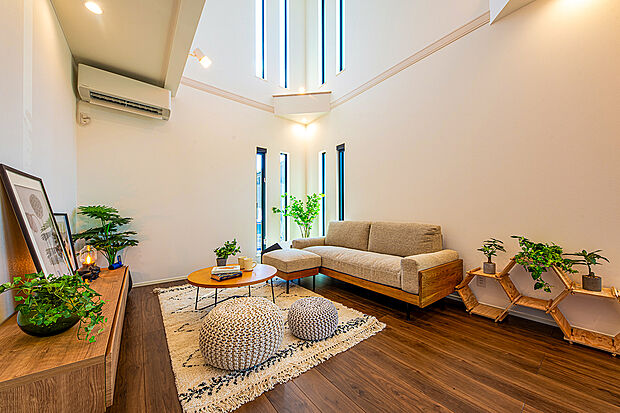 【【　住協建設の施工例　】】天井高を活かしたダイナミックな吹き抜け空間。スリット窓から光が降り注ぐ、開放感に満ちたリビング。