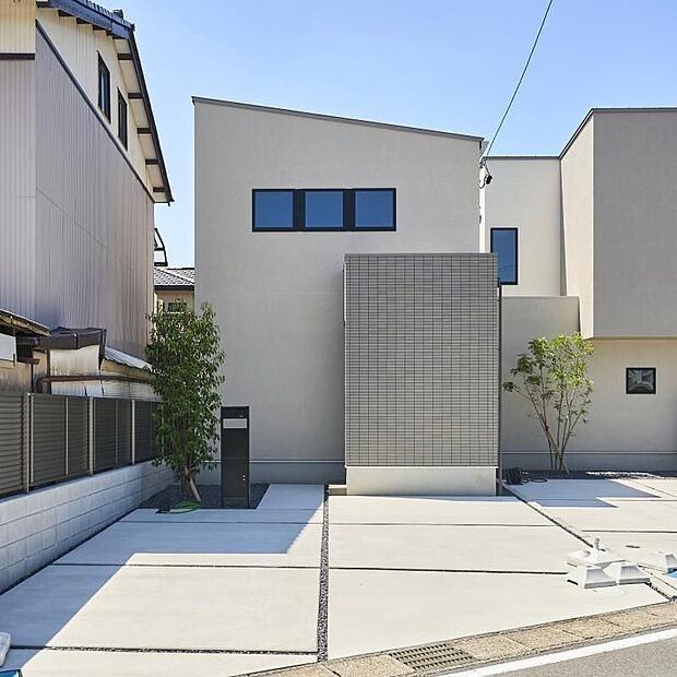 【B棟】シンプルでスタイリッシュな外観。直線的なフォルムとアクセントタイルが印象的で、植栽の緑が住まいに彩りを添えています。」※現地(2026年8月)撮影