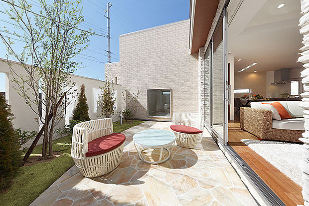 【当社施工例】広々としたアウトドアリビング。天気の良い日にはハンモックやデッキチェアを置いて、手軽に日光浴を楽しむことができます。リビングから一続きなので、自宅カフェとしても気軽に楽しめます。