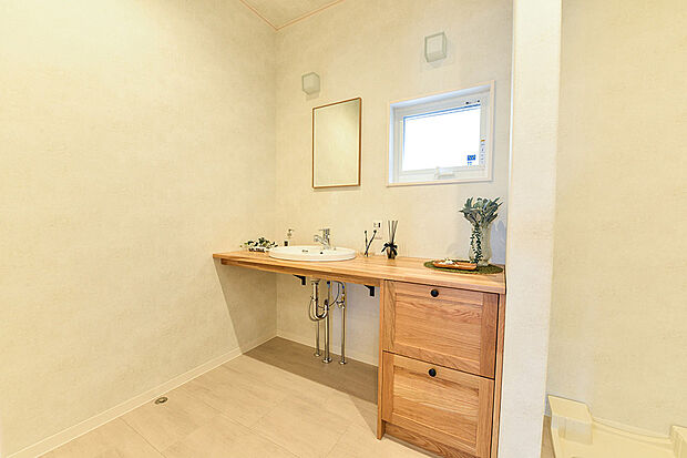 【当社施工例】洗面室に造作のワイドカウンターを設置。ナチュラルな木の雰囲気を大切にし、朝から気分良く準備ができます。玄関とリビングから出入りができる2WAYの動線を確保し、時短生活が送れます。