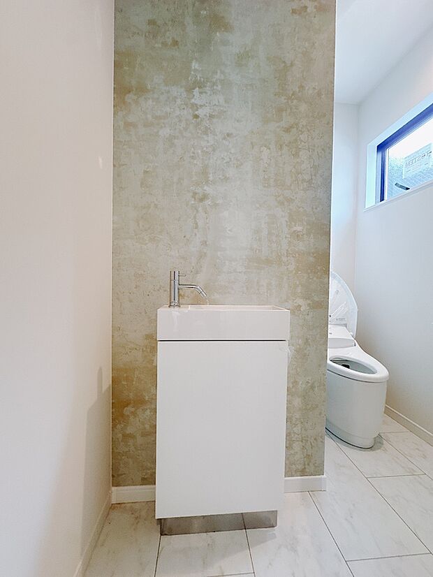 【【施工例】トイレ】スタイリッシュな独立手洗い台とタンクレストイレを採用。すっきりとしたデザインで掃除もしやすく、機能性と美しさを両立しました。