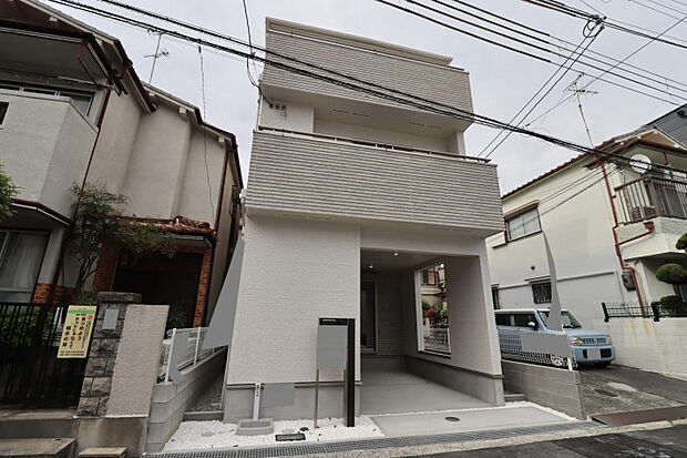 【外観写真】　前面道路から玄関をあえて見えない配置にすることで、家族のプライバシーをしっかり守ります。