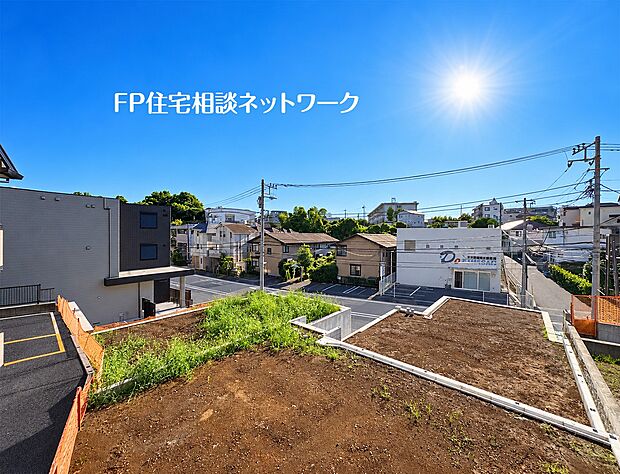 【現地土地写真】道路に面した雛壇地の売地です。更地になっており、コンクリート擁壁やフェンスが設置されています。自分好みのマイホームを建てるための、想像が膨らむ土地です。