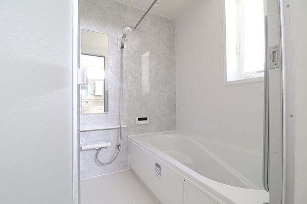 【システムバス】バスルームの入口は段差のないバリアフリー仕様。さまざまな年齢の方にも安心してご使用いただけます。浴室暖房乾燥機付き。洗い場が広くゆったりしたバスルームです。