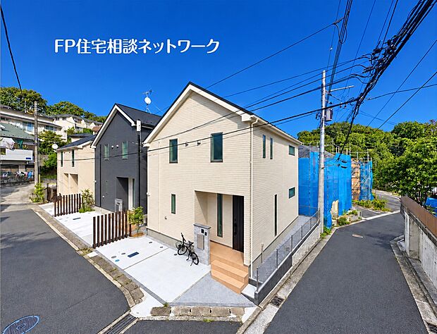 完成した住宅と、隣接する建築中の区画の様子です。完成済みの建物を見ることで、外壁の質感や駐車スペースの広さなど、実際の生活イメージや街並みの雰囲気が具体的に掴みやすくなります。