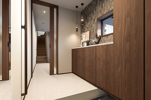 【玄関完成予想図】T-1/壁面に収納を備え、整然と美しい佇まい。調湿・脱臭効果のあるタイルで空気もデザインも心地よい、明るく爽やかな玄関。大理石のもつ風合いそのままの美しいタイルがLDKへと繋がります。