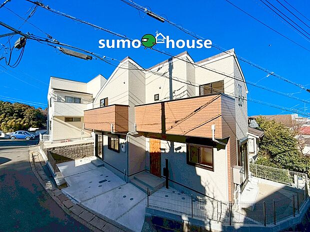 周囲に遮るものがなく、一日中豊かな陽光が差し込む心地よい住環境です。外観は落ち着いたグレーと温かみのある木目調バルコニーを組み合わせた、飽きのこないモダンな仕上がり。