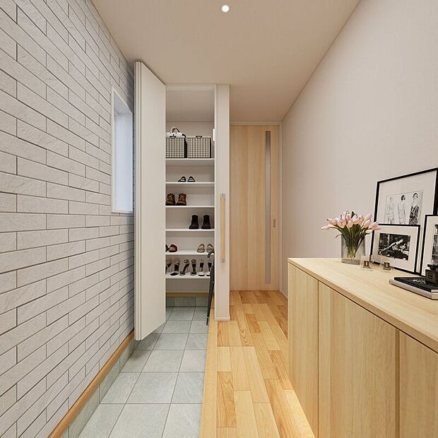 ■2号地玄関（パース）　1号地の玄関には、砂やホコリが目立ちにくい、グレーのタイルを採用しました。土間クロークとシューズボックスがあり、キレイな状態をキープできます。