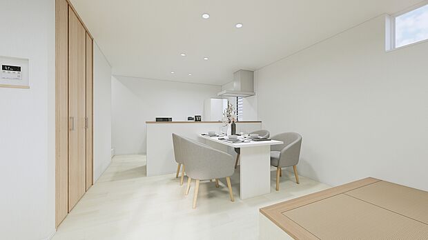 A号地:白と淡い木目でまとめた明るい空間。対面キッチンのそばに小上がりのタタミコーナーを設け、食事・くつろぎ・お子さまの遊び場まで心地よくつながります。