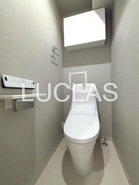 清潔感のある空間で、気持ちよくお使いいただけるトイレです。上部には収納スペースも備わっています。