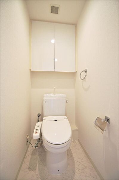画像15:トイレは温水洗浄機能付きです。上部収納も充実しております。