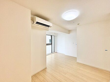 ナチュラルな木目調の床から木のぬくもりを感じられる広々としたリビングルーム。