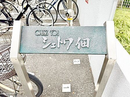 存在感のあるマンション名プレートは、落ち着きのある温かな空間を演出します。家族が笑顔になれる住まいへ。