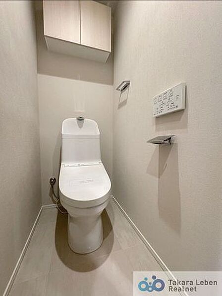 ウォシュレット機能付きのトイレは壁掛けリモコンの上位グレードを採用。便座がスッキリした印象となり、限られた空間を広く見せる効果があります。