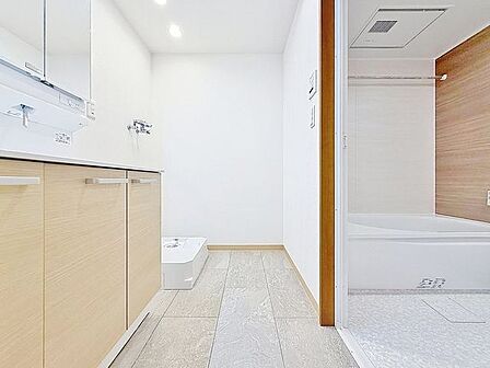 「清潔な印象の洗面室」明るく清潔感のある色調で纏められた洗面室は、機能性に富んだ三面鏡と使い勝手の良い収納を完備した洗面台を設置。洗濯機置場も完備し、大変充実しております。