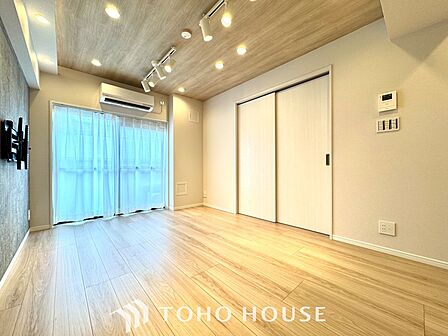 【Decorative lighting】上質に仕上げられた室内。オフ・ホワイトの壁を背にした観葉植物の葉をそっと置かれたインテリア・ライトが照らし出しています。少しお洒落な暮らしをしてみませんか。