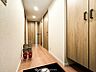 室内：上質感漂う廊下。居住者の帰り、訪れる方を優しく迎え安らぎに満ちた生活空間を予感させます。