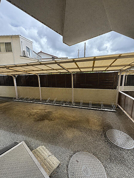 屋根付きの駐輪場です。ラック式で自転車を並べて停められ、雨の日も濡れにくい造りになっています。通勤通学の自転車置き場としてお使いいただけます。※AIによる家具消し加工を行なっております。