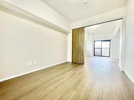 明るい色合いのフローリングが印象的な寝室です。スライドドアで空間を仕切ることができ使い勝手の良い間取りです。窓から自然光が入りやすく清潔感のある内装です。