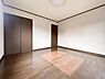 洋室：明るい洋室は落ち着いた色合いのフローリングと建具が調和しています。広々とした空間で使い勝手の良さが感じられます。収納スペースも備わっており室内をすっきりと保つことができます。