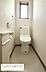 トイレ：窓付きで換気しやすいトイレです。清潔感のある内装が印象的です。ペーパーホルダーやリモコンも手元に配置されています。シンプルなデザインで空間がすっきりしています。