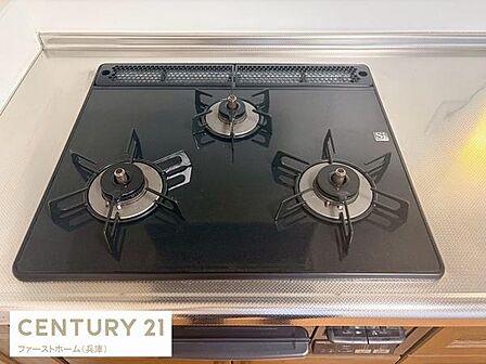 三口コンロが設置されておりお料理の幅が広がります。ガスコンロはシンプルなデザインでお手入れがしやすい仕様です。作業スペースもしっかり確保されています。キッチン周りがすっきりとまとまっています。